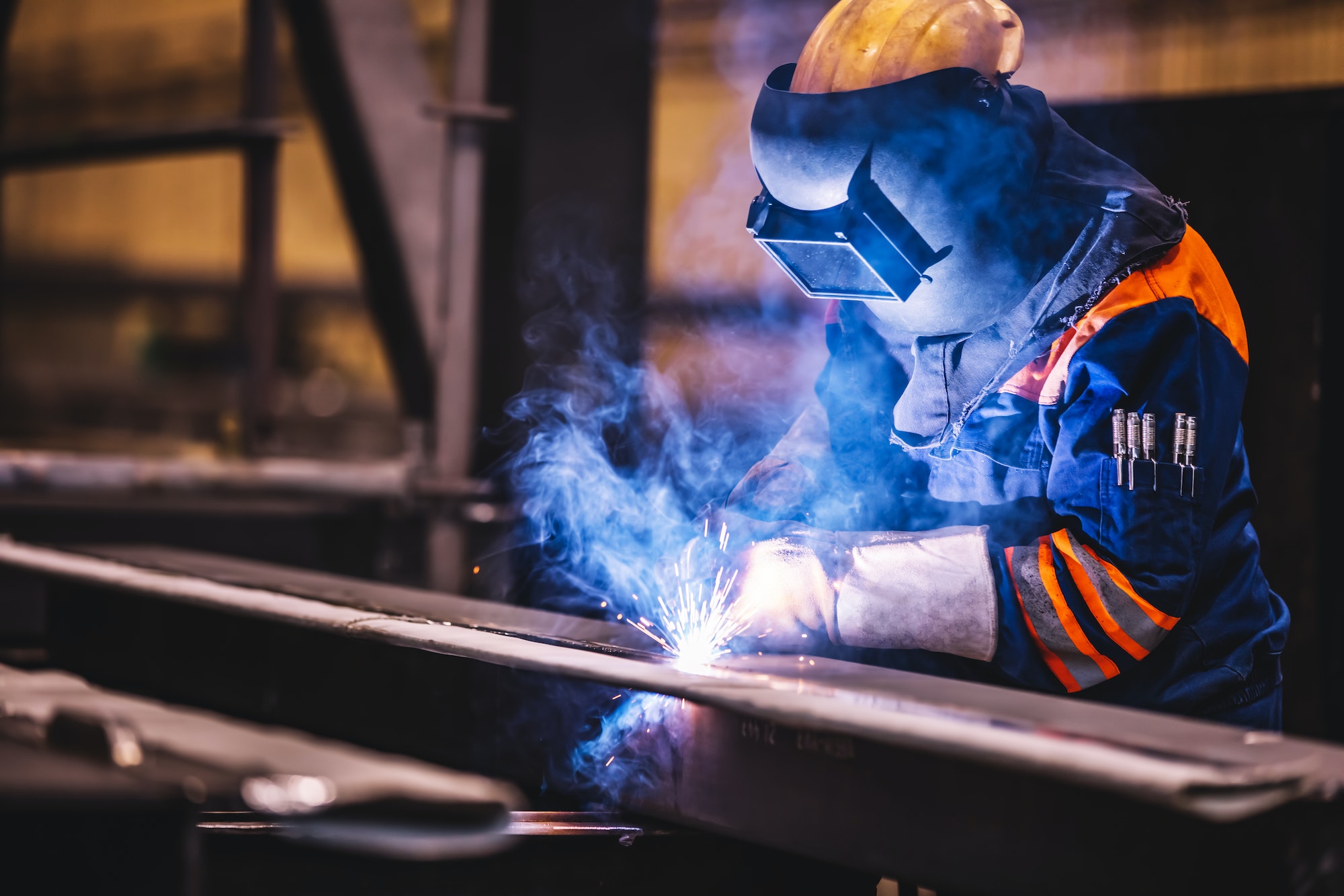 worker welding in a factory